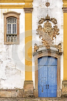 Old withe and yellow catholic church facade of the 18th century