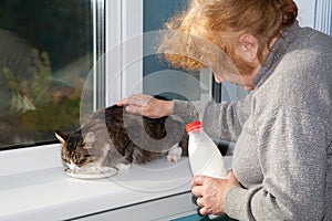 The old woman allows to have drink cat milk