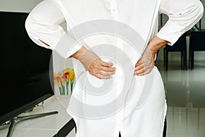 Old woman back pain at home, health problem concept