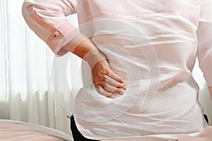 Old woman back pain at home, health problem concept