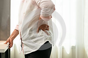 Old woman back pain at home, health problem concept