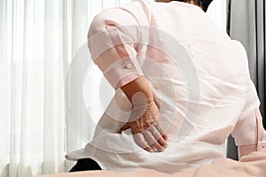 Old woman back pain at home, health problem concept