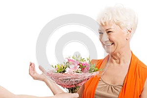 An old woman with bouquet of flowers.