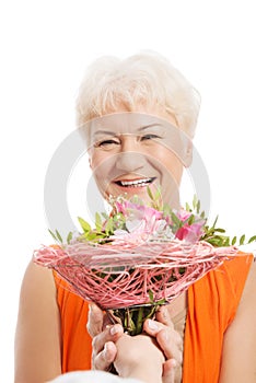 An old woman with bouquet of flowers.