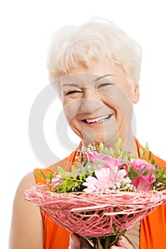 An old woman with bouquet of flowers.