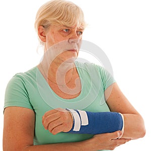 Old woman with broken wrist in gypsum