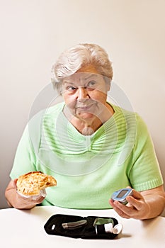 Old woman with bun and blood glucose meter