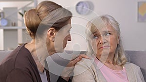 Old woman calming friend in time of trouble, relationship problems, divorce