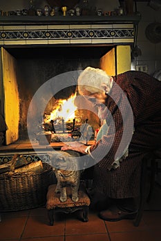 Old woman caressing her cat