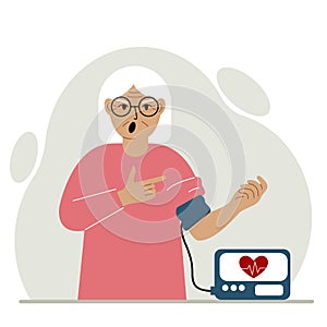 Old woman checks blood pressure. healthcare concept. Blood pressure measurement, digital tonometer. Health monitoring.