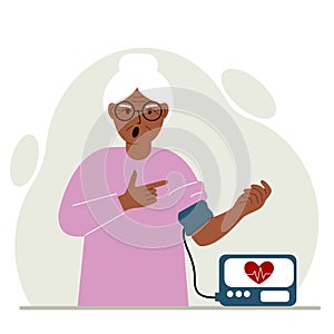 Old woman checks blood pressure. healthcare concept. Blood pressure measurement, digital tonometer. Health monitoring.