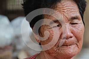 Old woman closes one's eyes