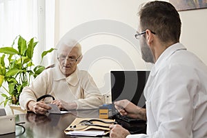 Old woman at the doctor geriatrician. geriatrician doctor with a patient in his office.