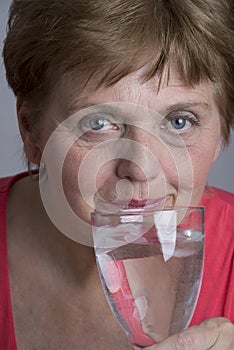 Old woman drinking mineral water