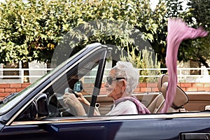 Old woman driving a convertible