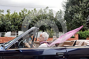 Old woman driving a convertible photo