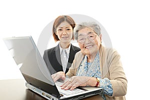 Old woman enjoys laptop computer photo