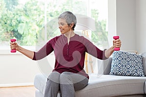 Old woman exercising with dumbbells