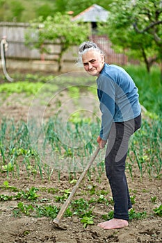 Old woman farmer in the garden