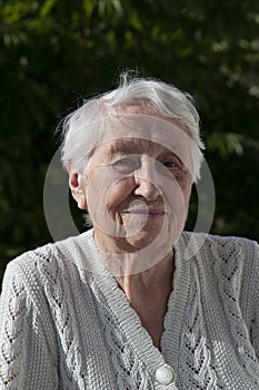 old woman with flowers on the balcony