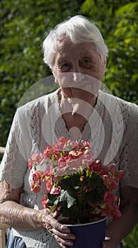 old woman with flowers on the balcony