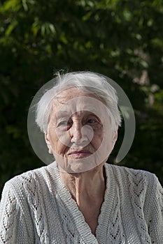 old woman with flowers on the balcony