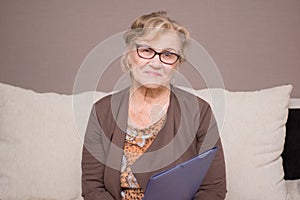 Old woman with a folder holding hands