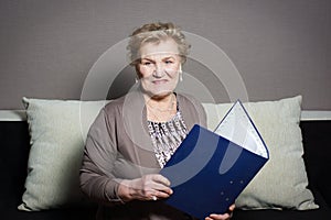 Old woman with a folder holding hands