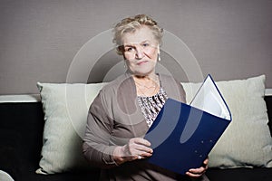 Old woman with a folder holding hands