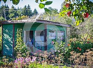 Old woman in garden house