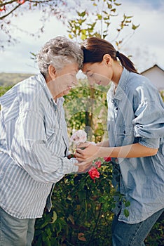 Old woman in a garden with young granddaughter