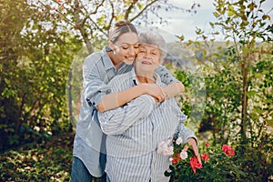 Old woman in a garden with young granddaughter