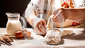 Old woman, grandmother hands with flour splash. Cooking bread slams ball dough on white powder covered table. concept of nature,
