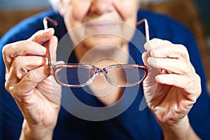 Old woman hands with eyeglasses