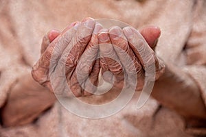 Old woman hands praying for god rising her hands