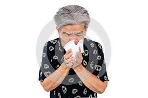 An old woman have a cold, uses a tissue to cover her mouth when coughing and sneezing