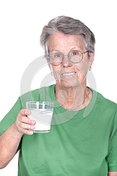 Old woman holding a glass of milk