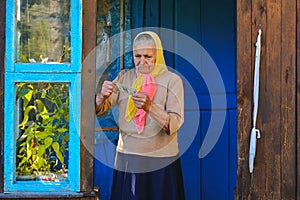 The old woman is holding money in her hands. An elderly woman with dollars in her hands