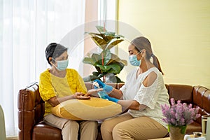 Old woman  in hospital with daughter taking care with protective face mask.  Health care and medicine concept