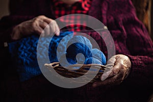 The old woman knits garments