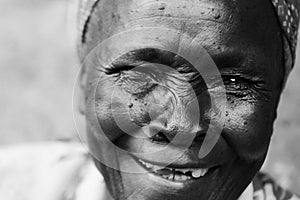 An old woman laughing with no teeth