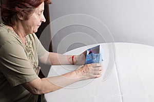 Old woman looking at gift box accepting present