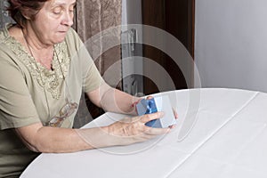 Old woman looking at gift box accepting present