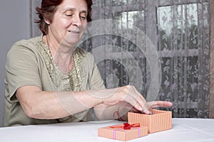 Old woman looking at gift box accepting present