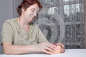 Old woman looking at gift box accepting present