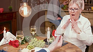 Old woman looking schocked at the ring that her husband gave