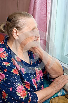 The old woman looks out of the window