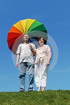 Old woman and man holding umbrella