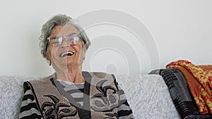 Old woman with mental health problems due to old age smiles