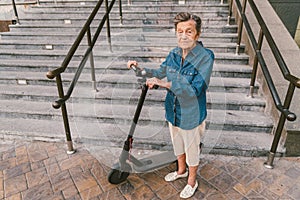 Old woman near scooter. Grandmother progressive woman. Senior having fun. Old woman enjoying her hobbies. Retired lady